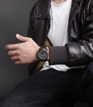 Load image into Gallery viewer, Person wearing a black leather jacket and watch on a dark background
